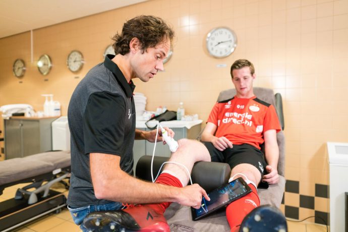 Wart van Zoest, PSV’s Medical Director is using Philips’ Lumify portable ultrasound to diagnose an injury of a young football player. (Photo courtesy: Philips)