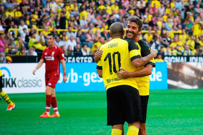 Egyptian star Mohamed Zidan and 1990 FIFA World Cup winner Karl-Heinz Riedle celebrating during the Borussia Dortmund vs Liverpool FC Legends Match at the BVB Season Opening on August 11, 2018. (© CPD Football)