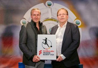 FLYERALARM CEO Thorsten Fischer and DFB Vice President Dr. Rainer Koch present the new logo of the FLYERALARM Frauen-Bundesliga (Women's Bundesliga). (Photo courtesy: FLYERALARM)