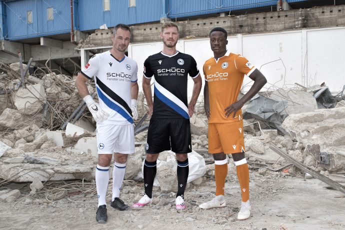 The DSC Arminia Bielefeld kits for the 2020-21 Bundesliga season - left to right: Former club goalkeeper Dennis Eilhoff in the away kit, captain Fabian Klos in the home kit and U-19 player Kenson Bauer in the third kit. (Photo © www.sport-vision-pro.de / DSC Arminia Bielefeld)